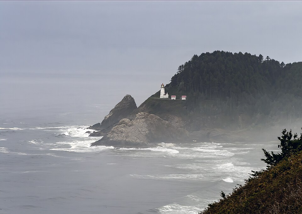Heceta Head Lighthouse on a misty Oregon headland above the surf