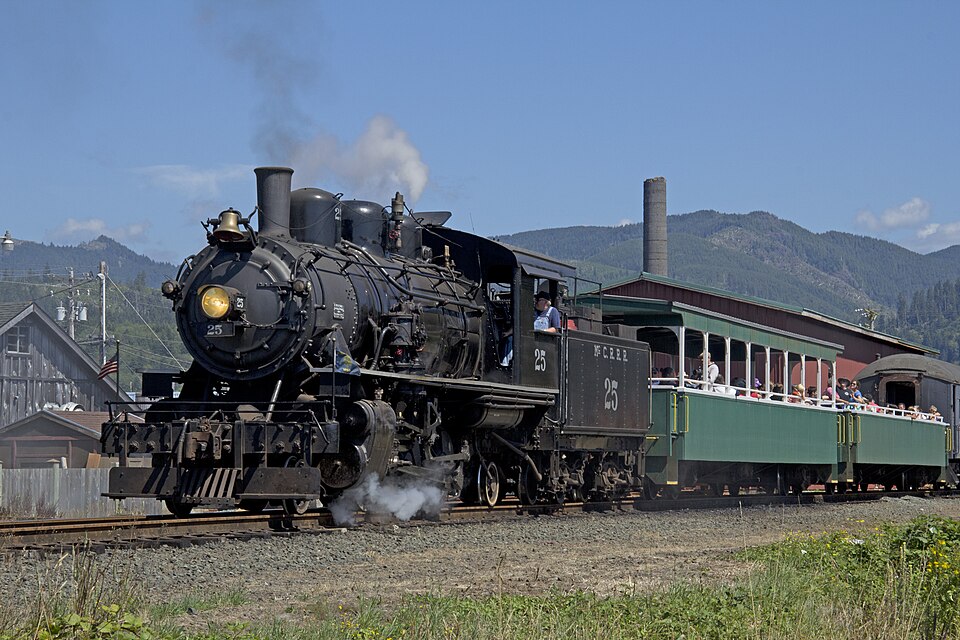 The Oregon Coast Scenic Railroad steam train pulling open-air coaches near Garibaldi